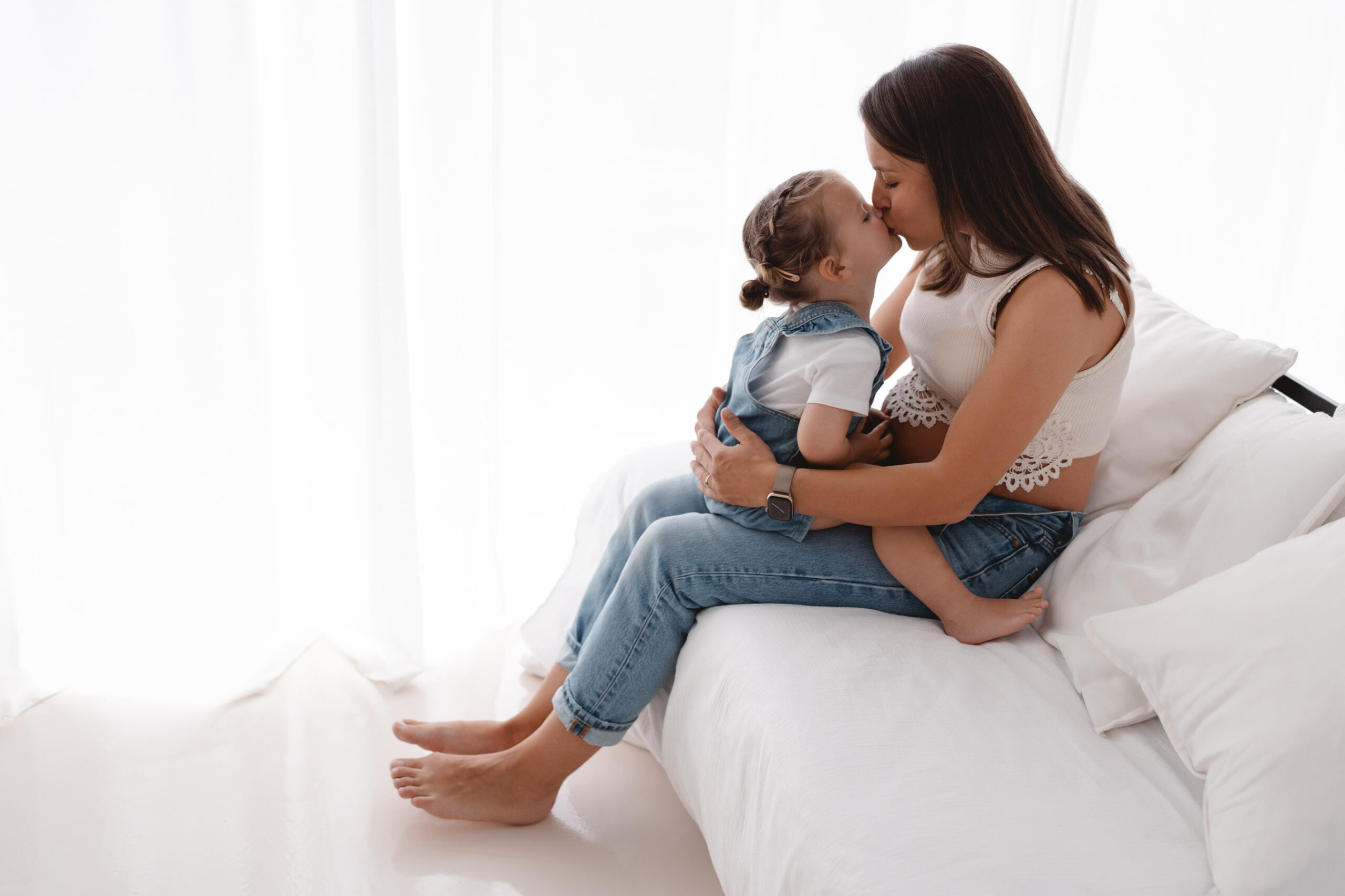 Kind küsst Mama, Babybauchshooting im cleanen Look